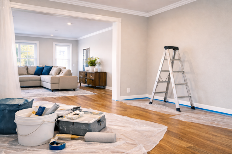 freshly painted living room with clean cut-in lines and covered furniture