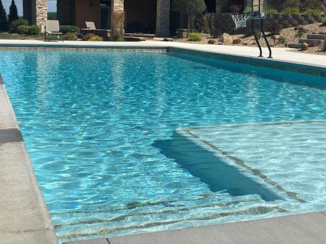 Modern concrete swimming pool with a freshly coated blue finish in a Perth residential backyard