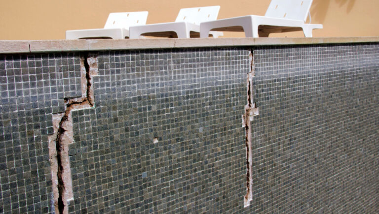 Concrete swimming pool showing peeling coating and surface deterioration in Perth