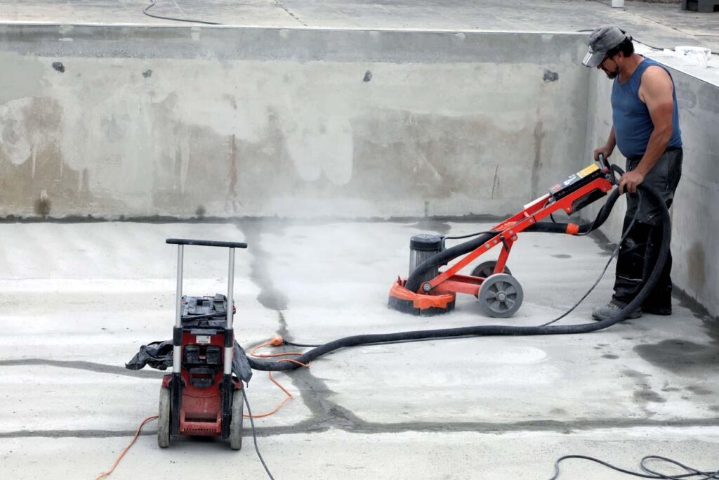 Professional surface preparation of a concrete swimming pool before coating application