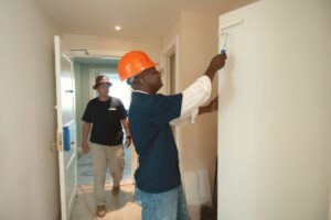 Painter applying paint to an interior wall
