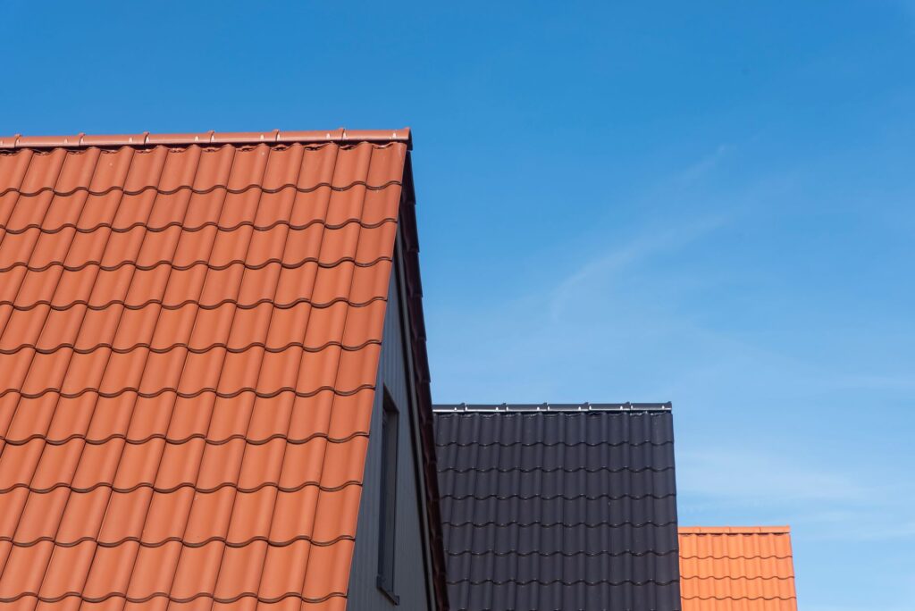 Vibrant rooftops contrasting with clear blue sky, showcasing architecture, roof painting perth