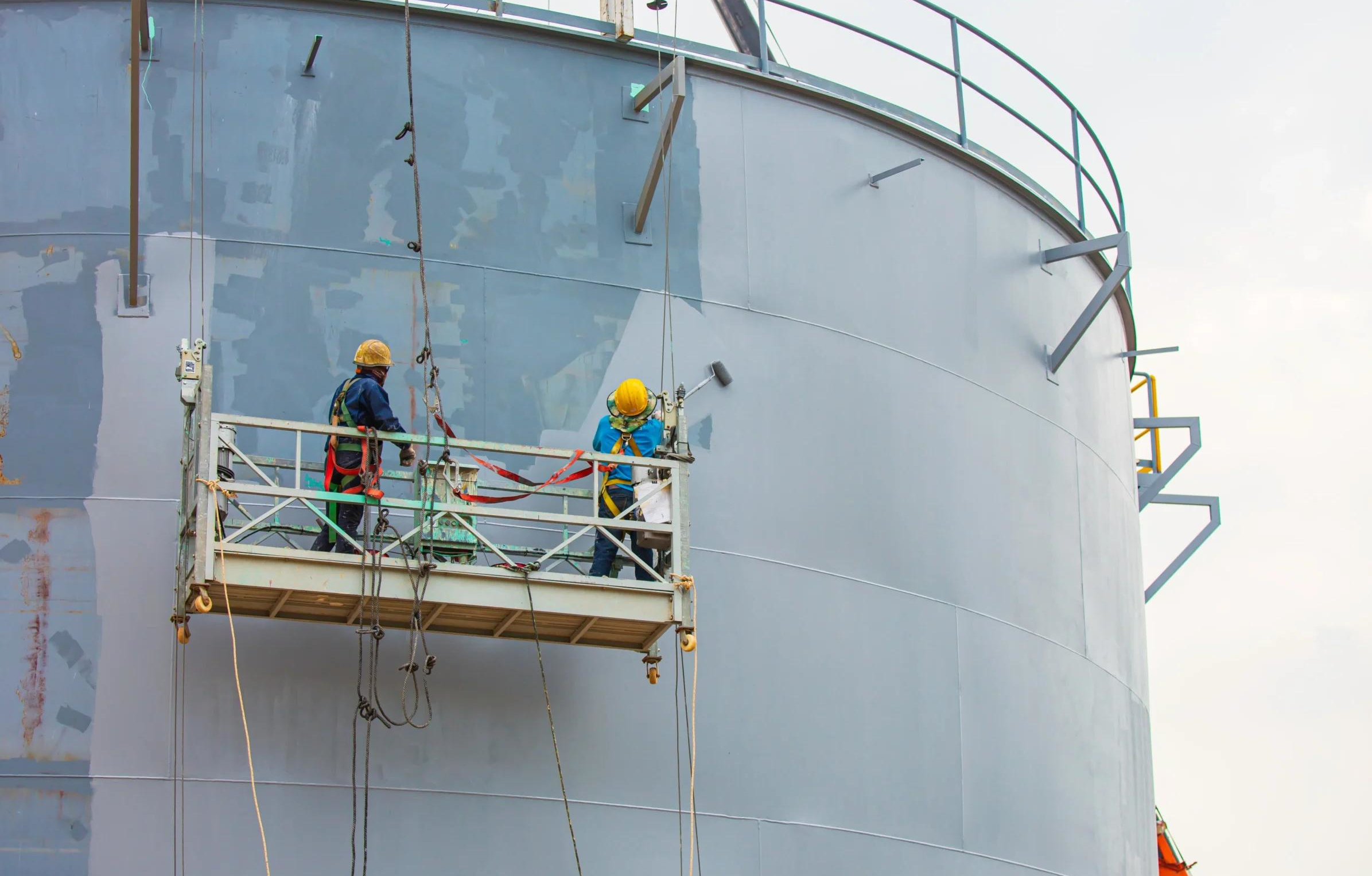 Industrial painters working on an elevated platform at an industrial facility in Perth