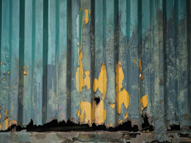 Shipping container with surface rust and deteriorating exterior paintwork