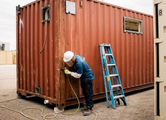 Surface preparation on a shipping container before painting